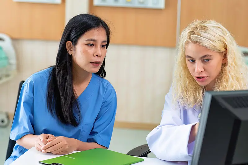 2 healthcare workers discussing health related issues