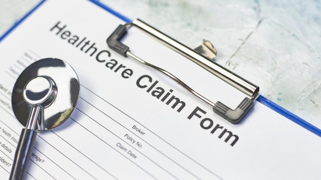 A healthcare claim form with a stethoscope placed on top, symbolizing the medical billing process