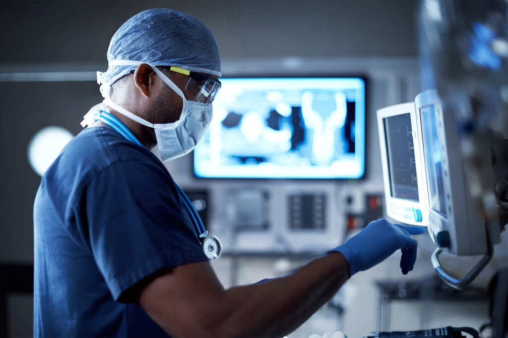 A healthcare professional adjusting a medical device in a high-tech hospital setting, with medical imaging on the screen
