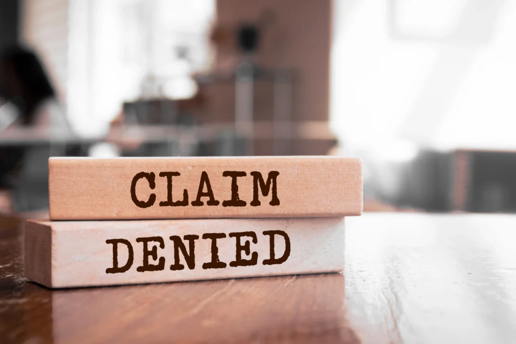 Wooden blocks with CLAIM DENIED printed on them
