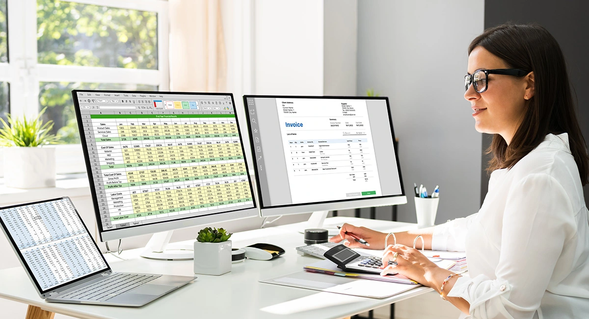 a female medical biller working on codes on 2 pcs