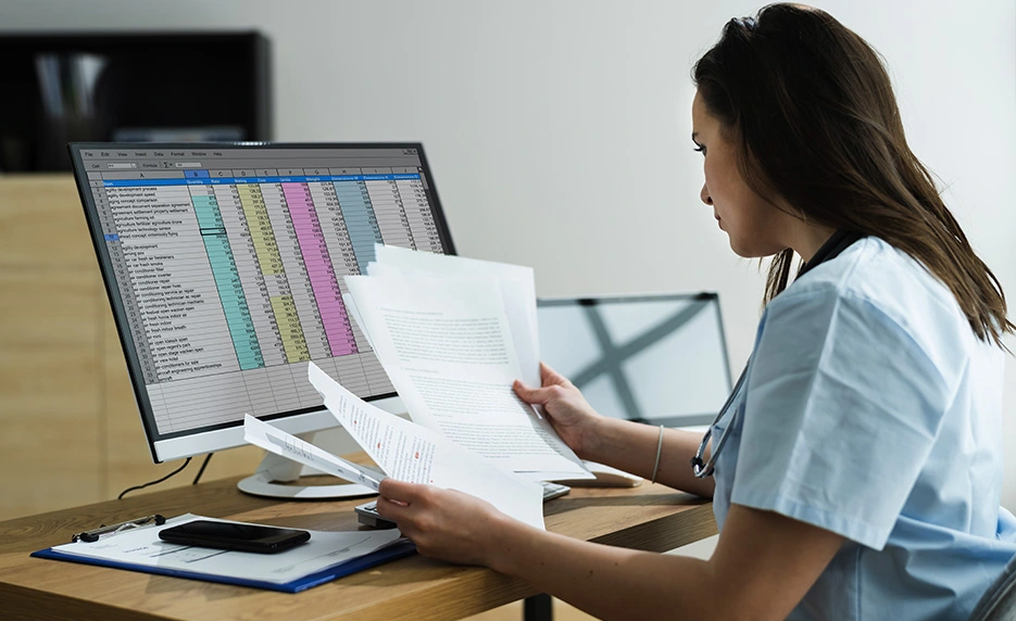 a-healthcare-worker-juggling-medical-documents