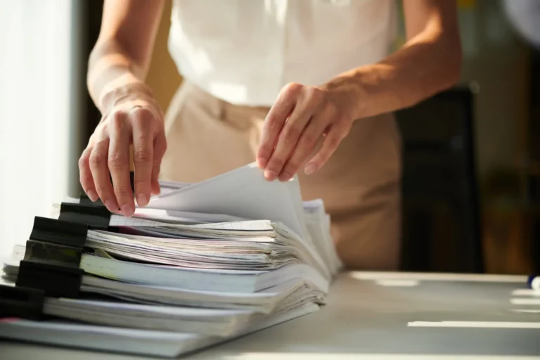 close up of female hands sorting documents