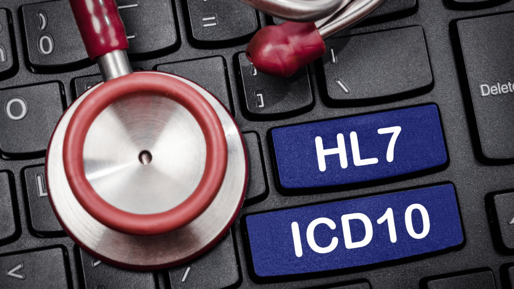 A stethoscope on a keyboard with HL7 and ICD10 keys.