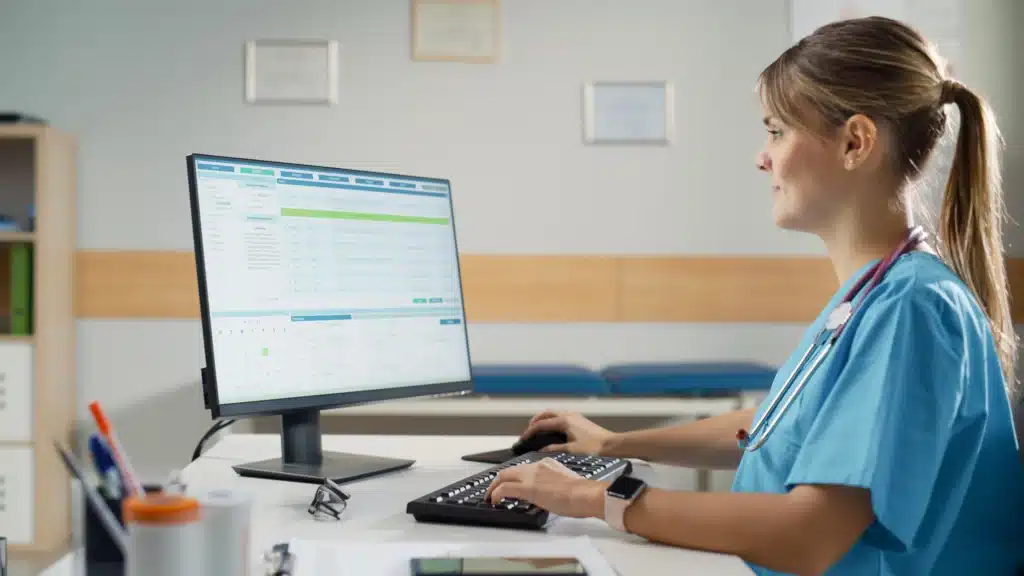  Nurse working on a computer in a medical office.
