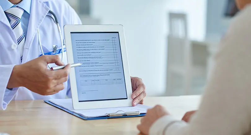 a-doctor-showing-EHR-of-a-patient-in-a-tablet
