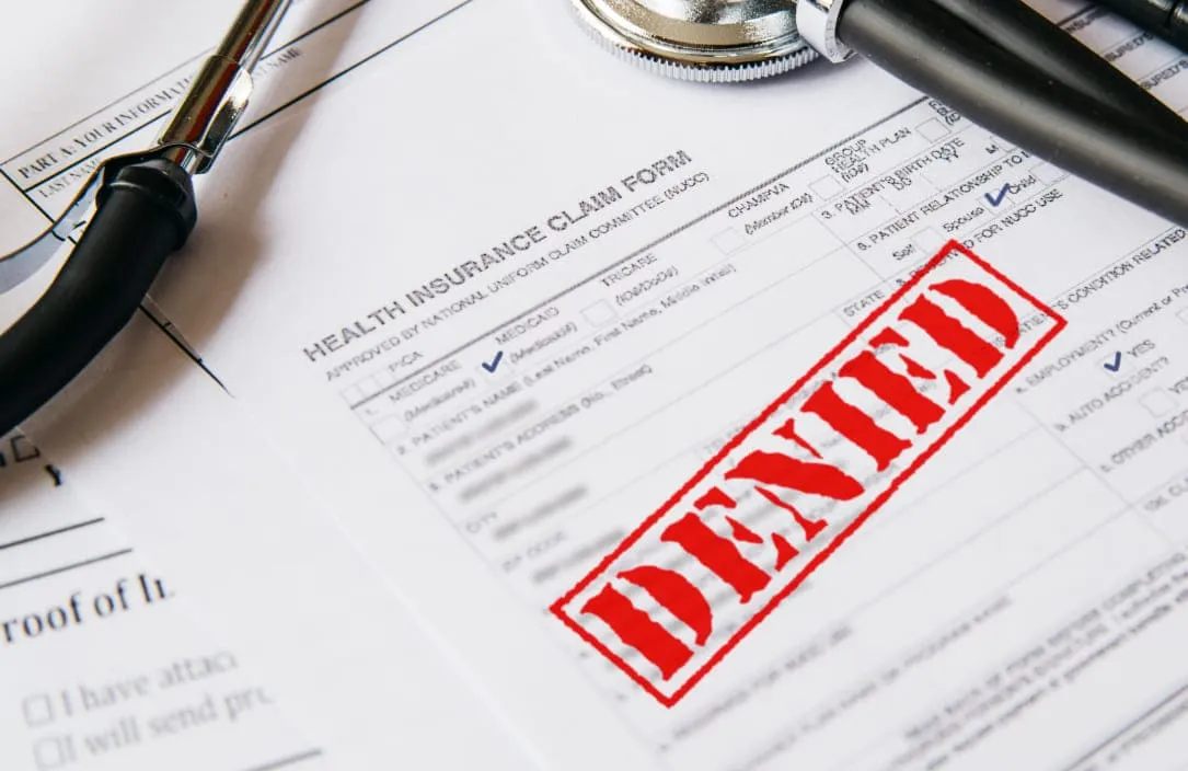 medical billing claim paper and denied written on it