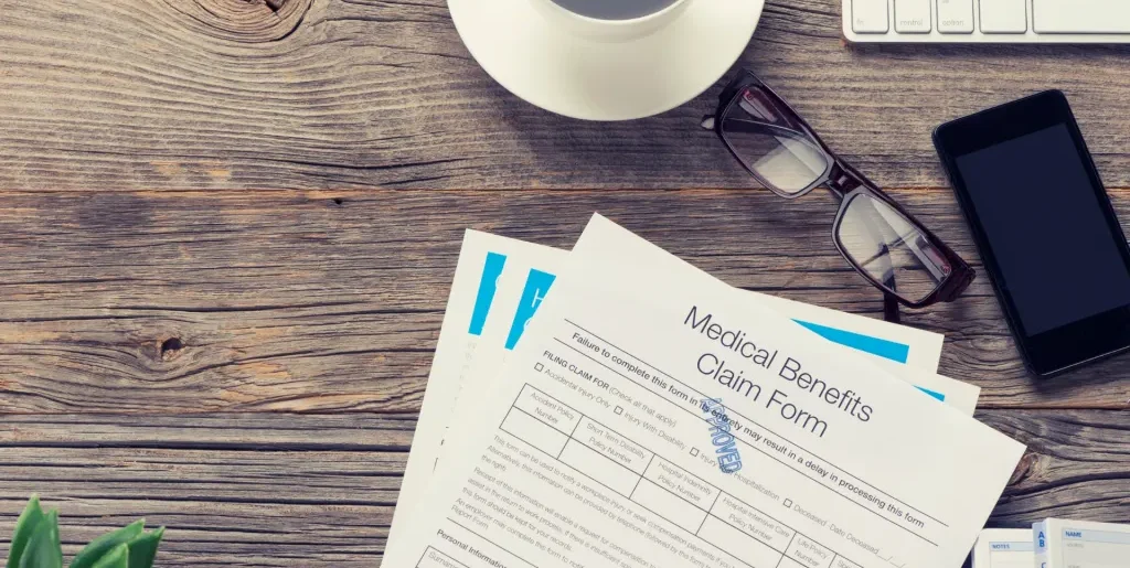 medical claim form on a wooden surface