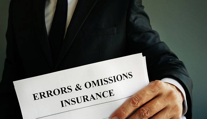 view of a man holding a paper written Errors and omission insurance on it