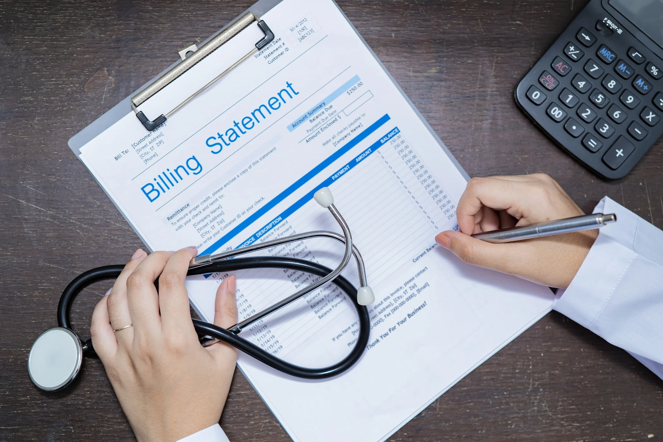 A doctor reviewing a billing statement with a stethoscope and a calculator on the desk