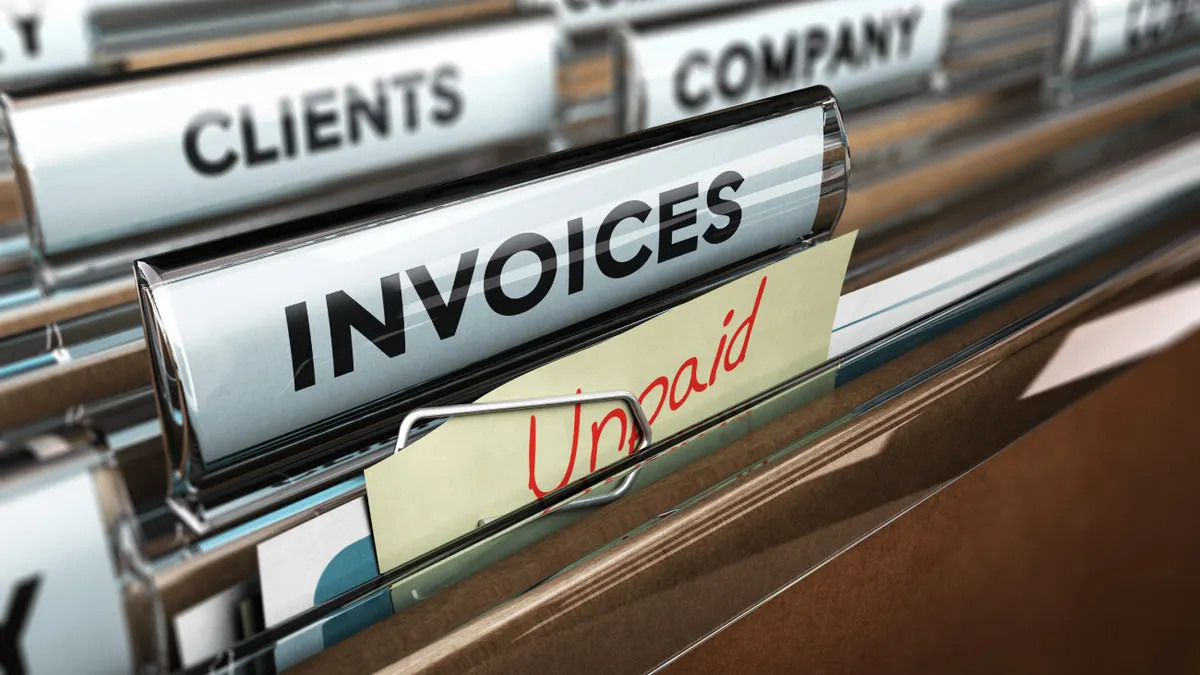 Unpaid invoices neatly organized in a file folder, highlighting accounts receivable management.