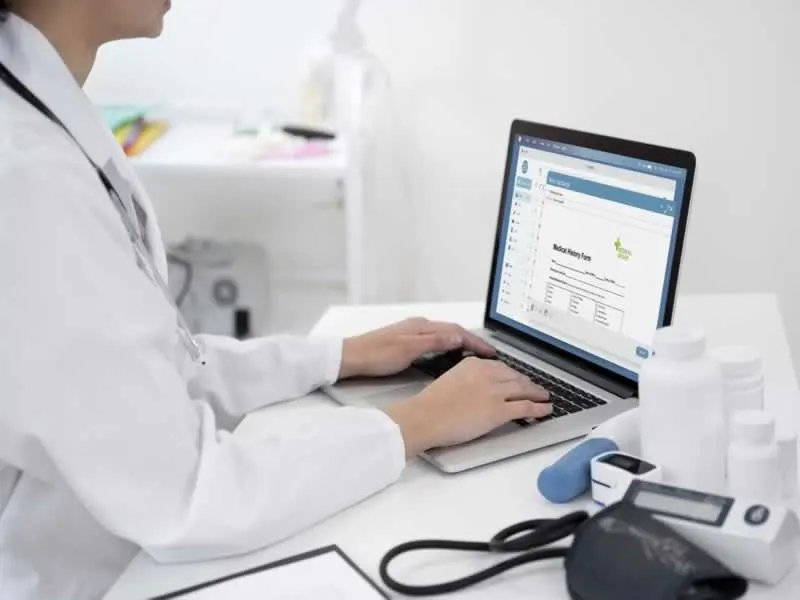Healthcare professional using medical billing software on a laptop.