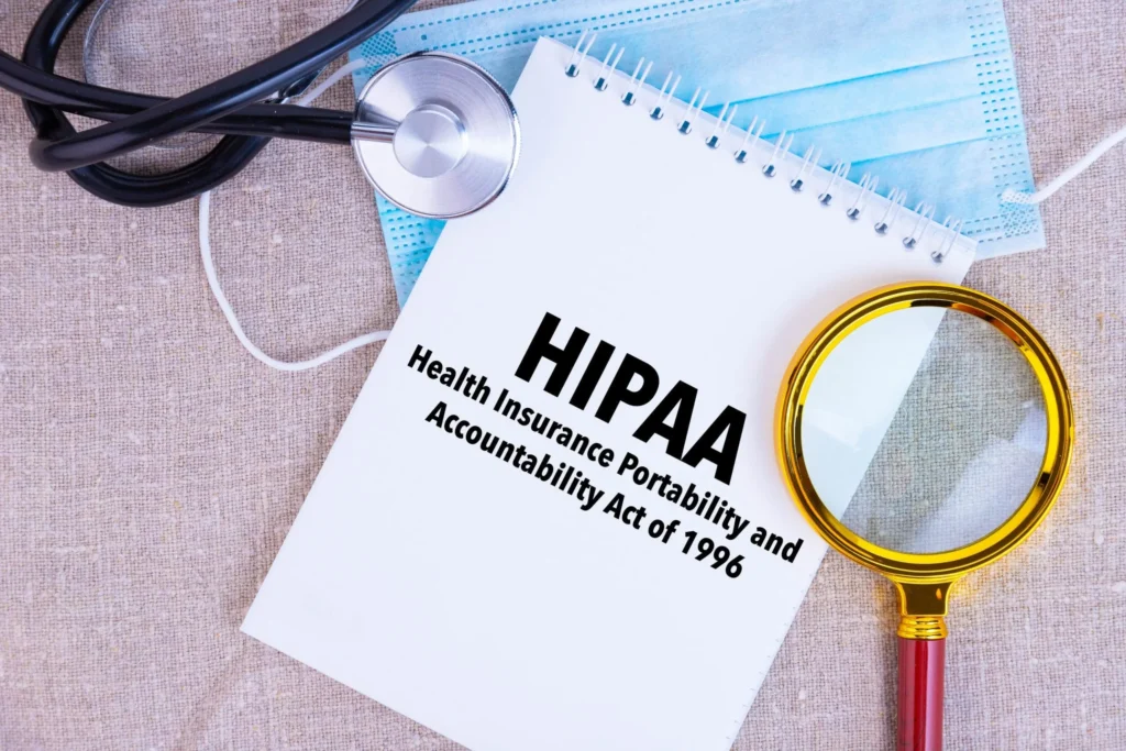 Notepad with HIPAA Health Insurance Portability and Accountability Act of 1996, stethoscope, and mask.